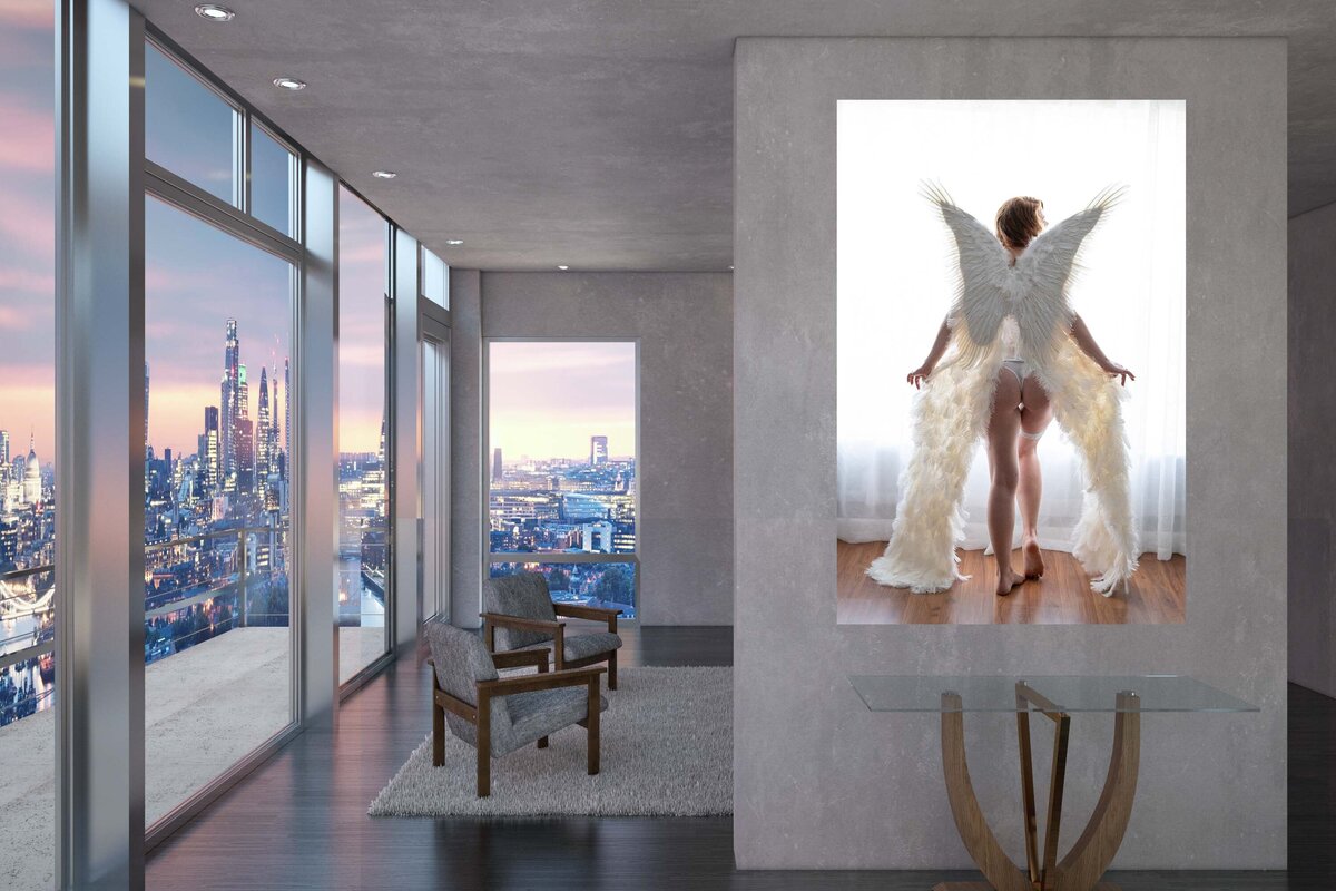 A canvas of a woman wearing angel wings. It is hung on the hallway.