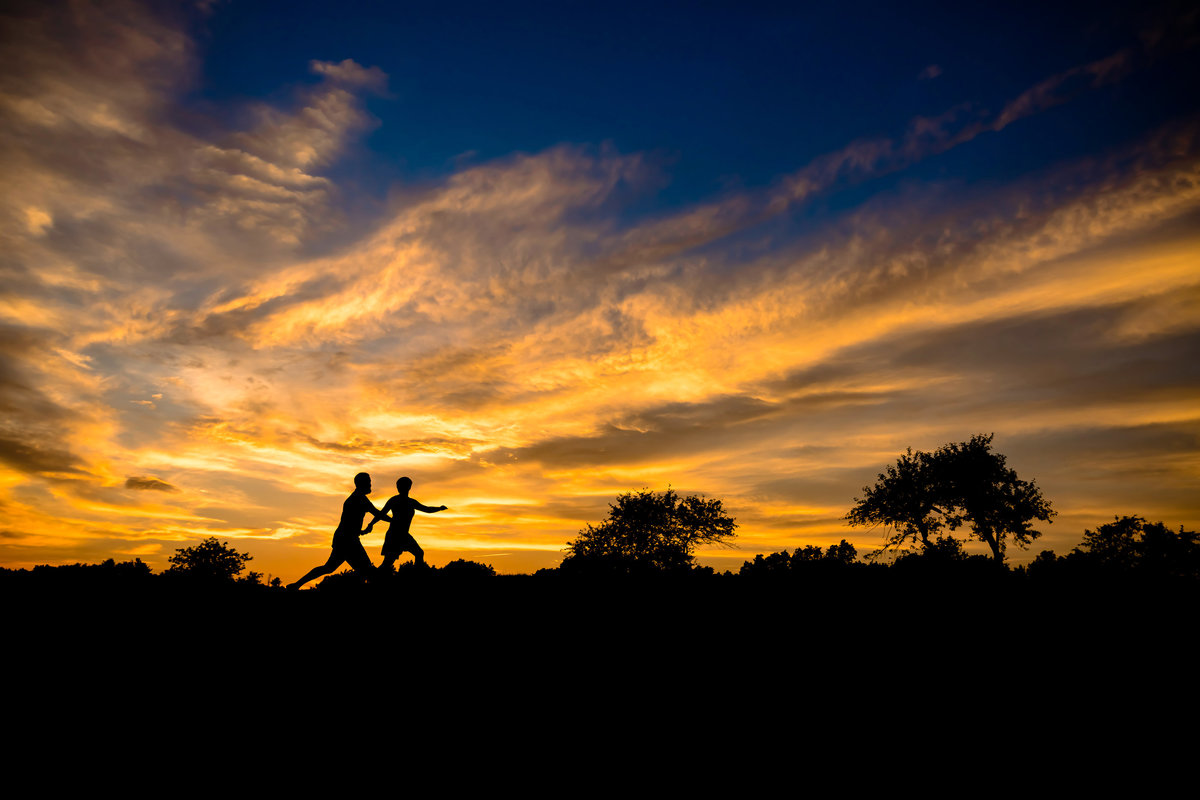 A sunset serves as a backdrop for the couple during their Dover NH engagement session