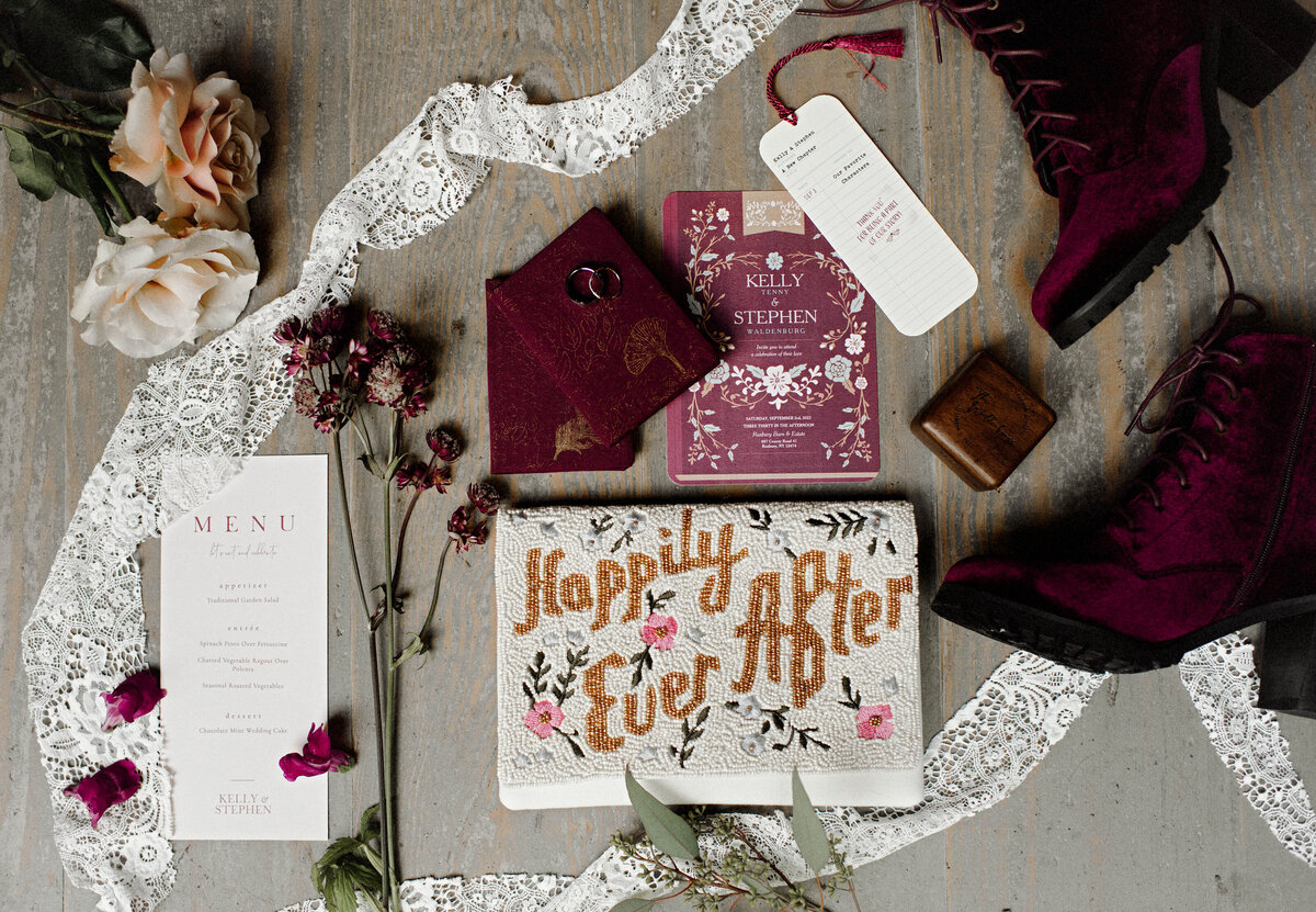 Burgundy White and Blush wedding items and a bag that says Happily Ever After