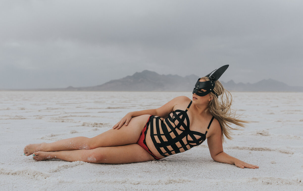 Woman wearing a leather mask and body harness