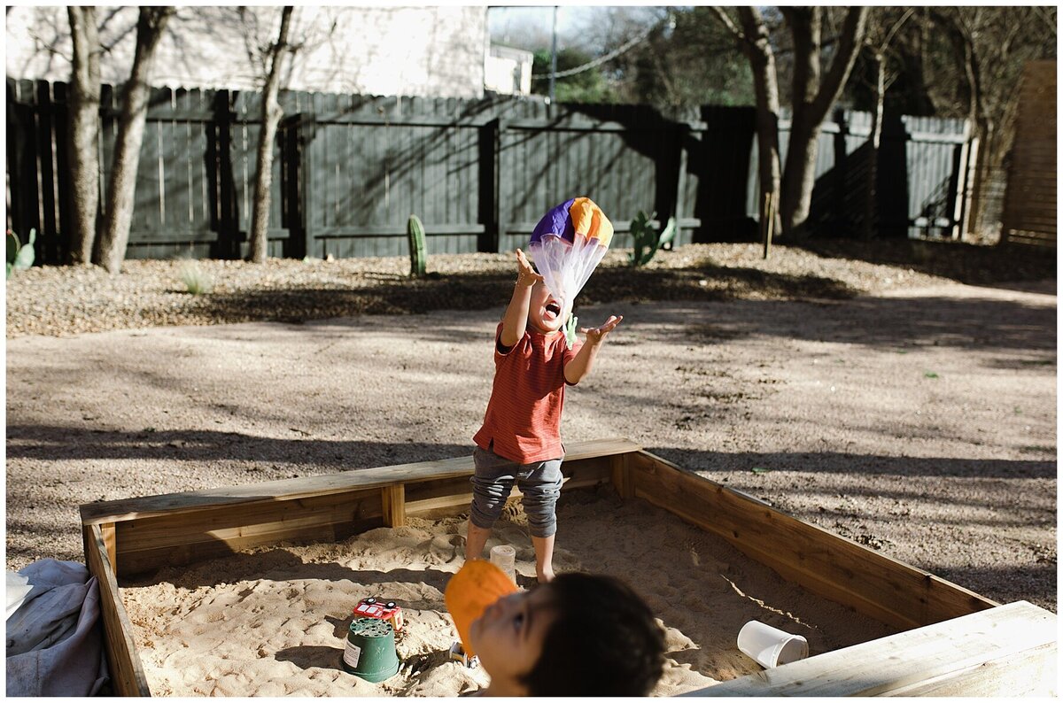 Children playing in a sand pit at  garden family session in Austin by Amber Vickery Photography