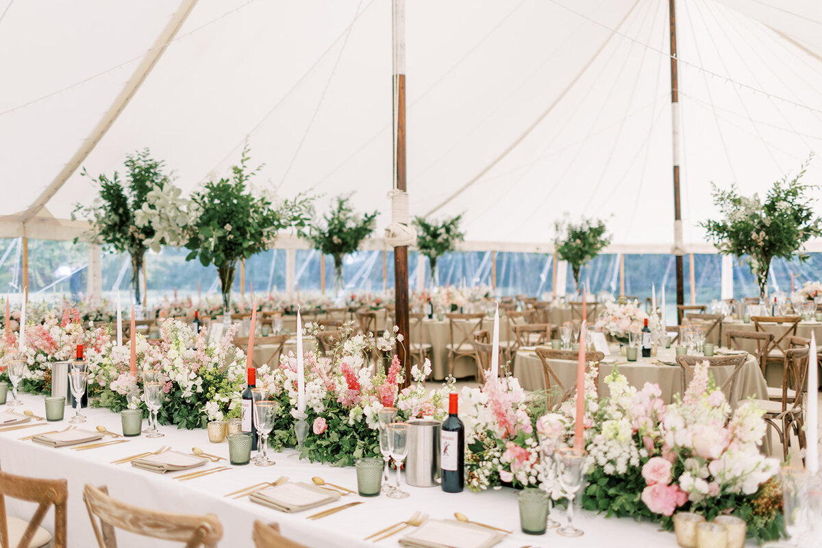 Elegant marquee reception at Cornwell Manor featuring long tables and loop-back chairs, beautifully arranged for a wedding celebration by Chenai  Events.