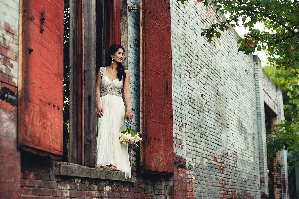 bride posing in window
