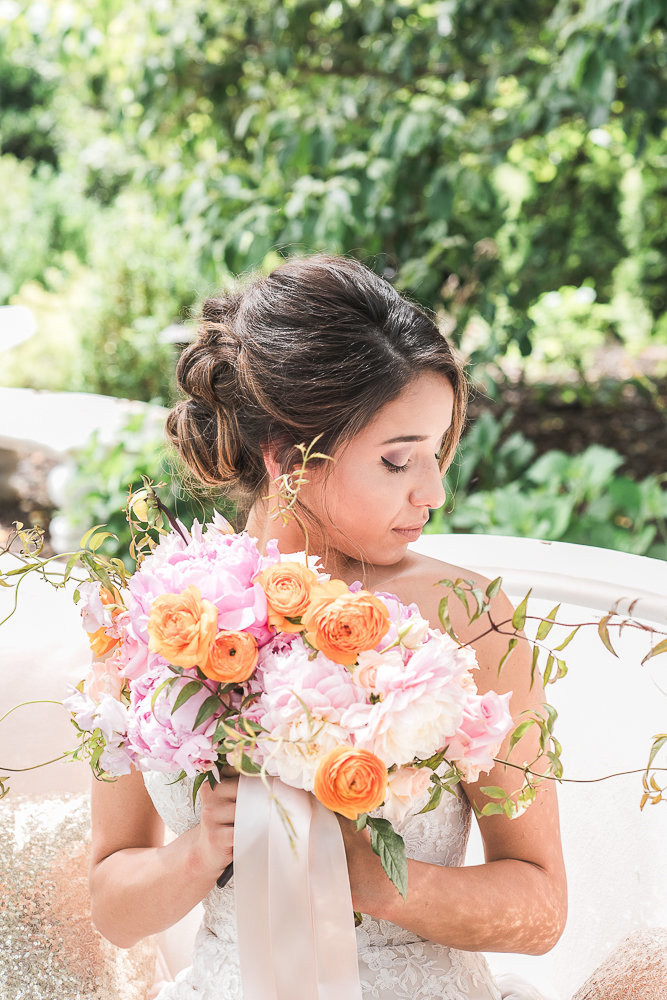 Spanish bride with orange, pink, and white bouquet