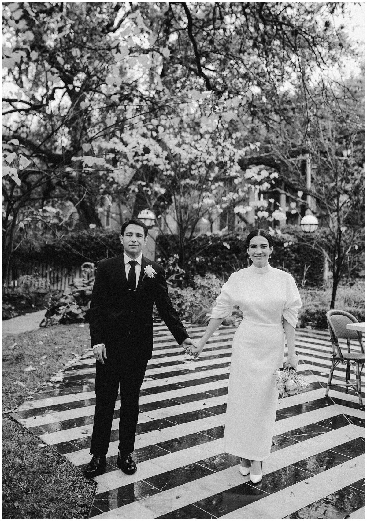 bride and groom walking on a black and white floor at the hotel saint cecilia Austin