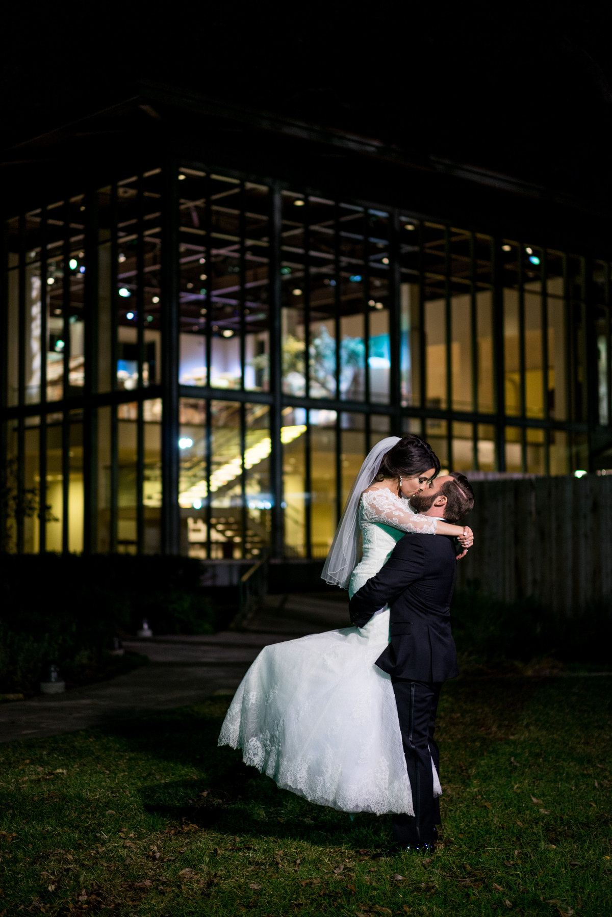 groom lifting bride in the air and kissing her at Witte Museum wedding venue in San Antonio