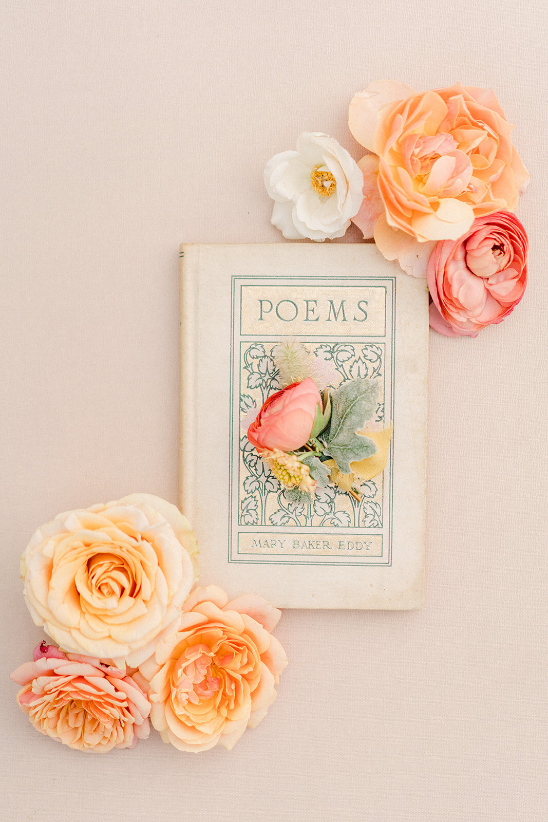 a book about poems with orange and pink florals on it