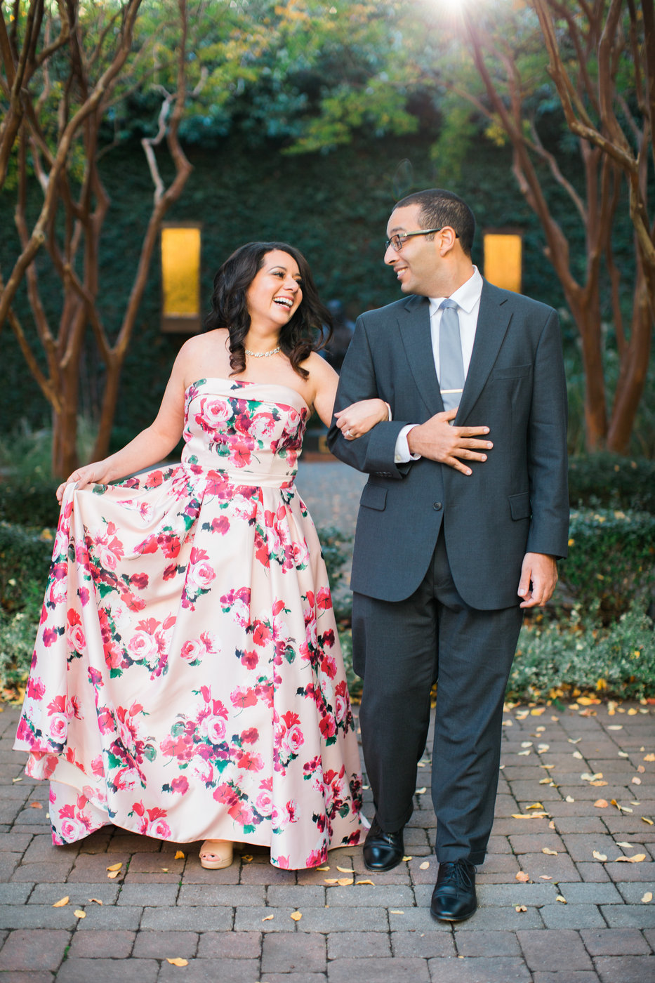 Wedding Photographer, woman in floral dressing walking arm in arm with her man