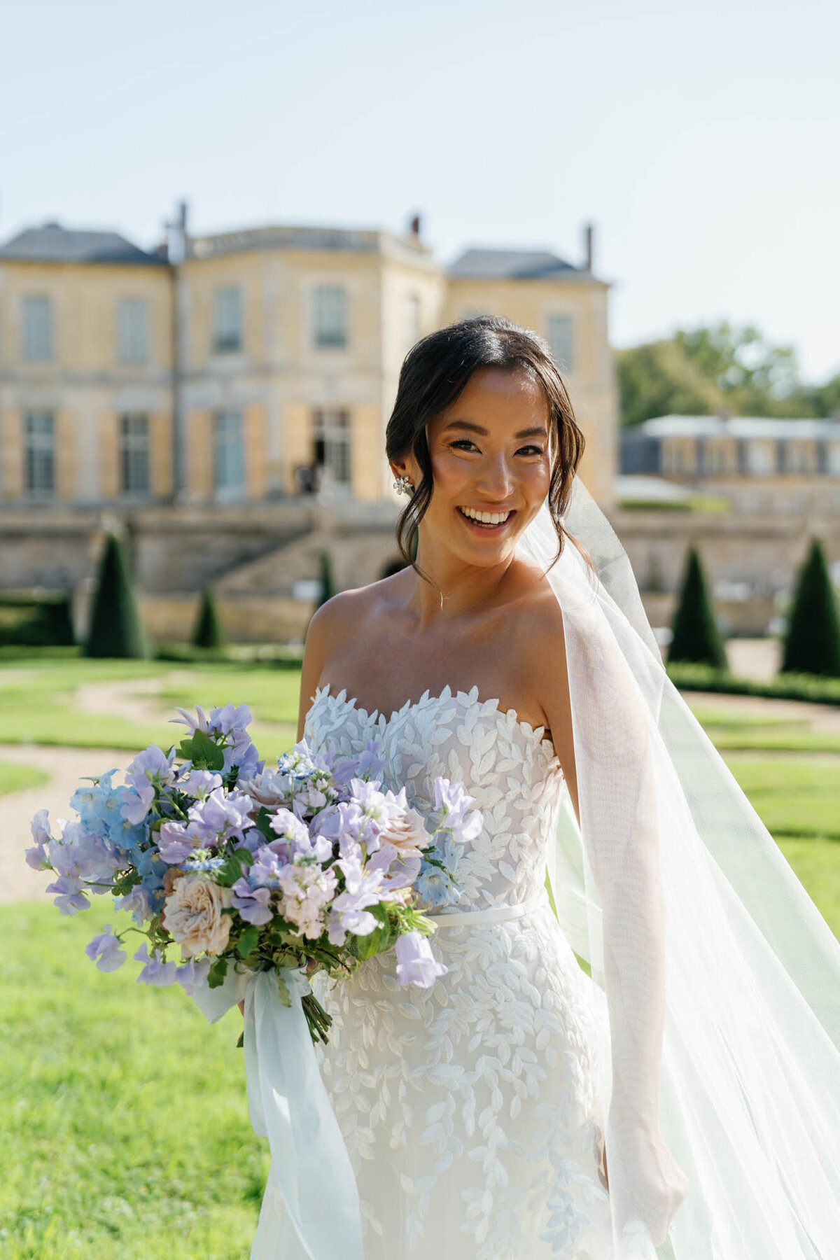 a bride smiling with her bouquet