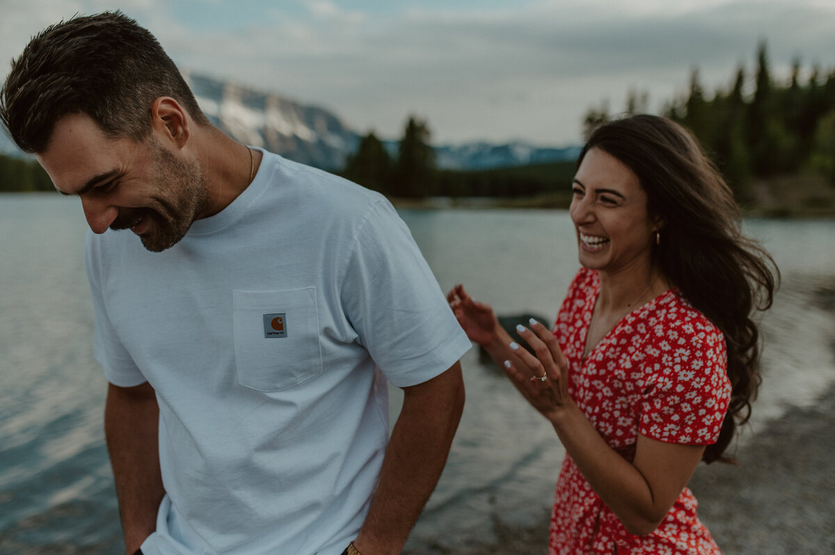 candid laughing couple during engagement session in banff