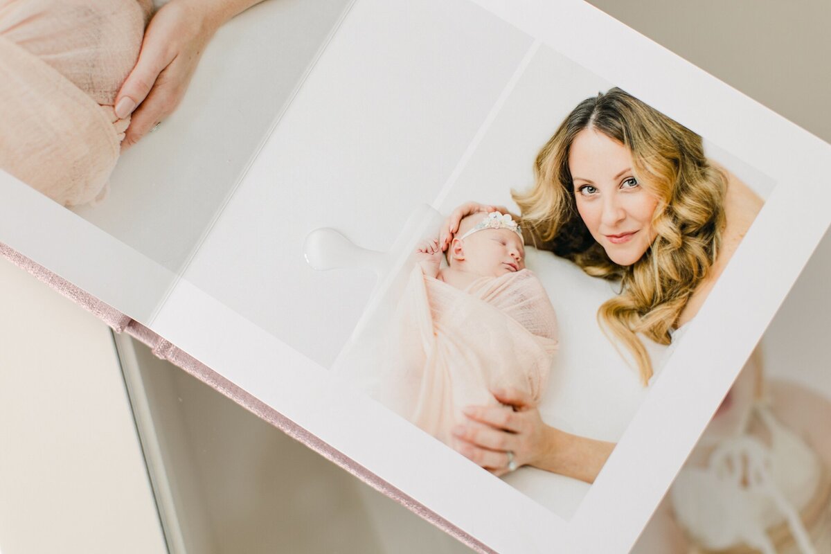 newborn album opened to photo of mom and baby