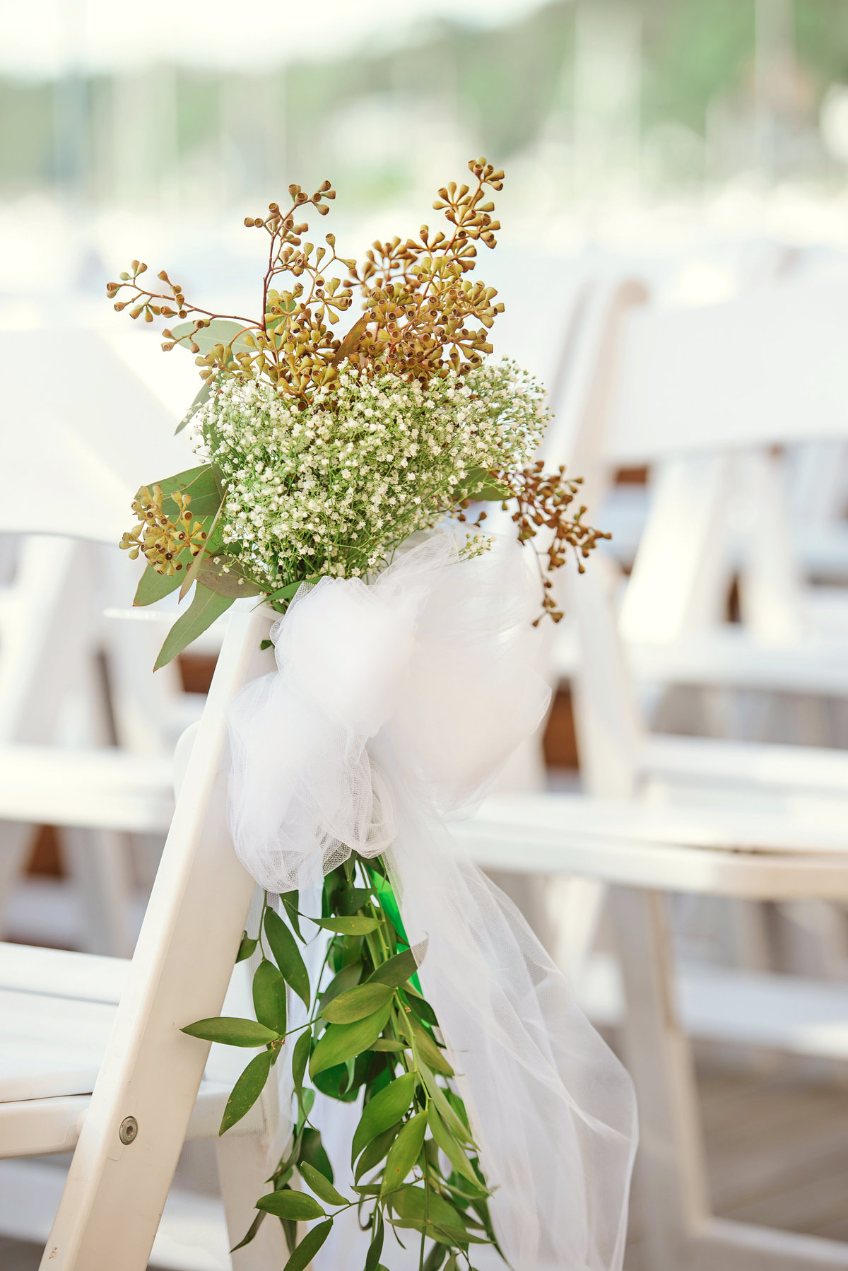 Baby breath flowers placed on chairs for wedding ceremony