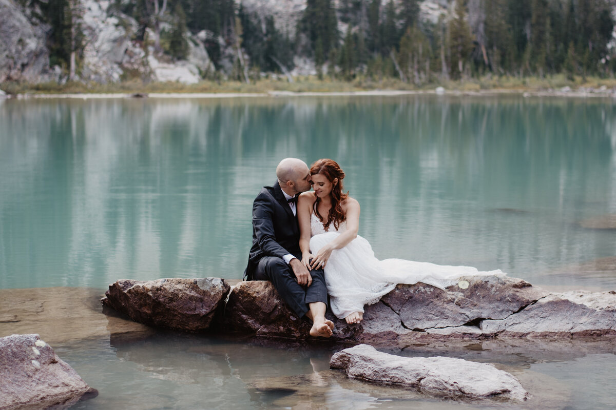 Jackson Hole Photographers capture man kissing woman's hair after Grand Teton elopement