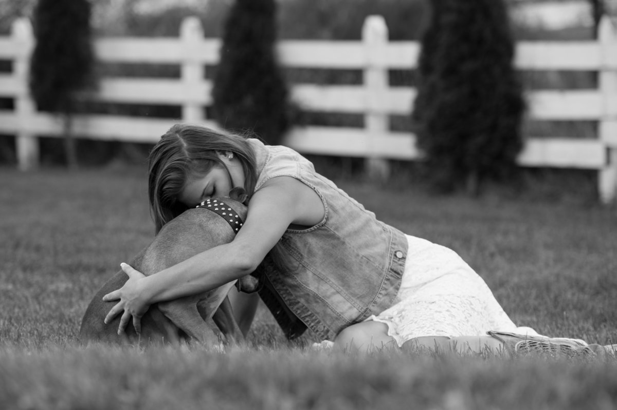 girl hugging dog black and white photo
