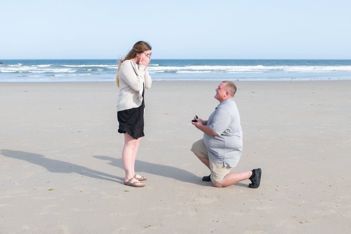 Man proposing to girlfriend on Wells Beach Maine