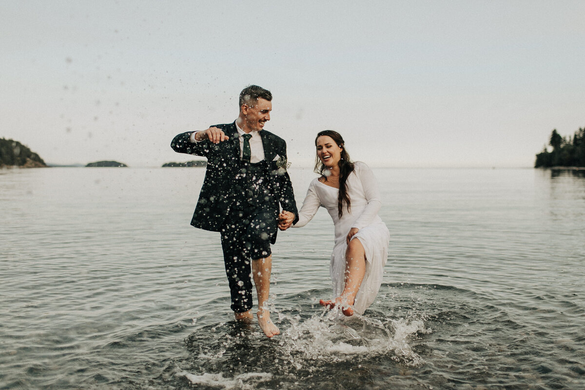 bride and groom in ocean sunshine coast bc sechelt