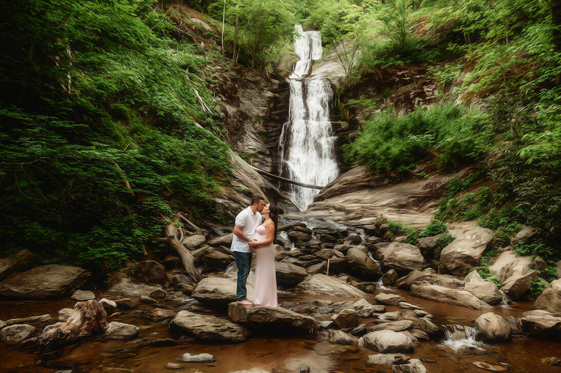 Expectant parents pose for Maternity Photoshoot at a Waterfall in Asheville, NC.