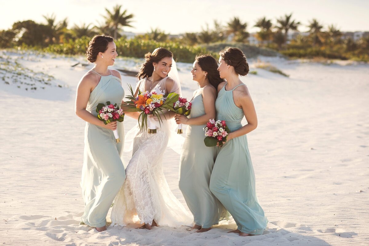 Bridesmaids on beach in after wedding in Cancun