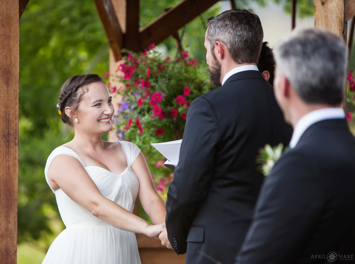 Beaming bride during outdoor wedding ceremony at Denver Botanic Gardens Chatfield Farms