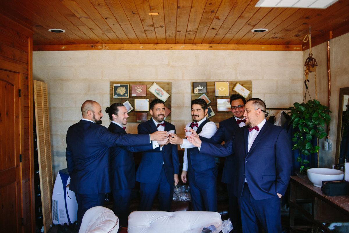 groom and groomsmen toast during getting ready right before ceremony at Oaks at Heavenly venue