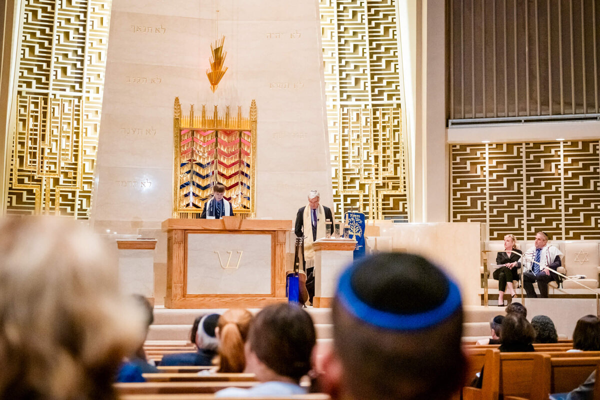 A view from the congregation as a boy reads from the torah