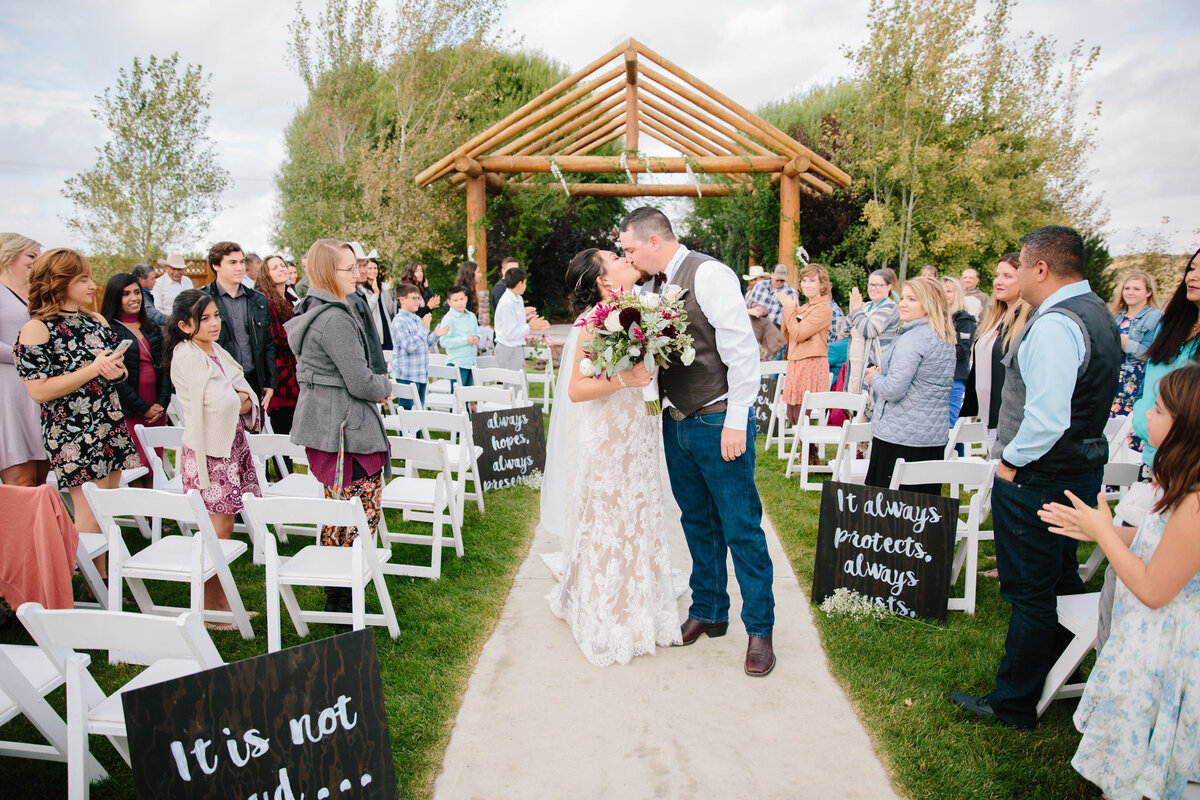 Jackson Hole photographers capture couple kissing after wedding ceremony