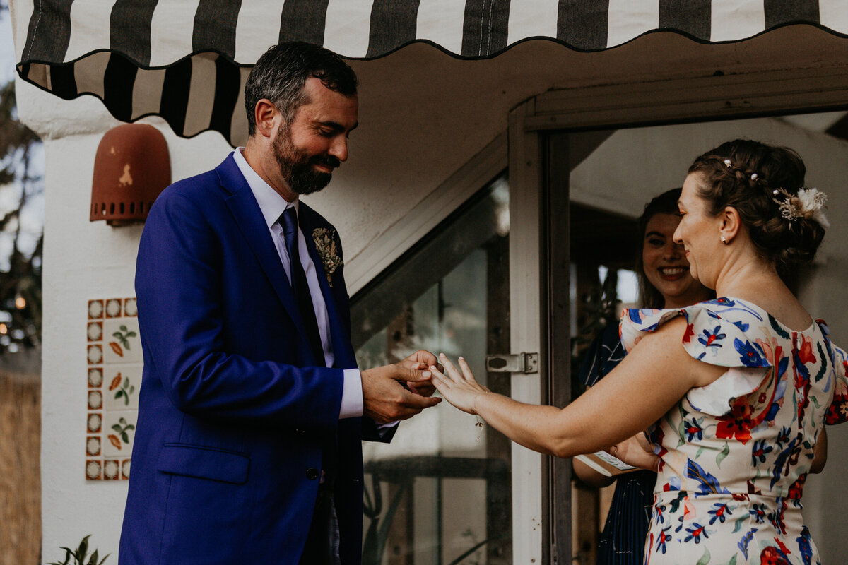 bride and groom exchanging rings during ceremony