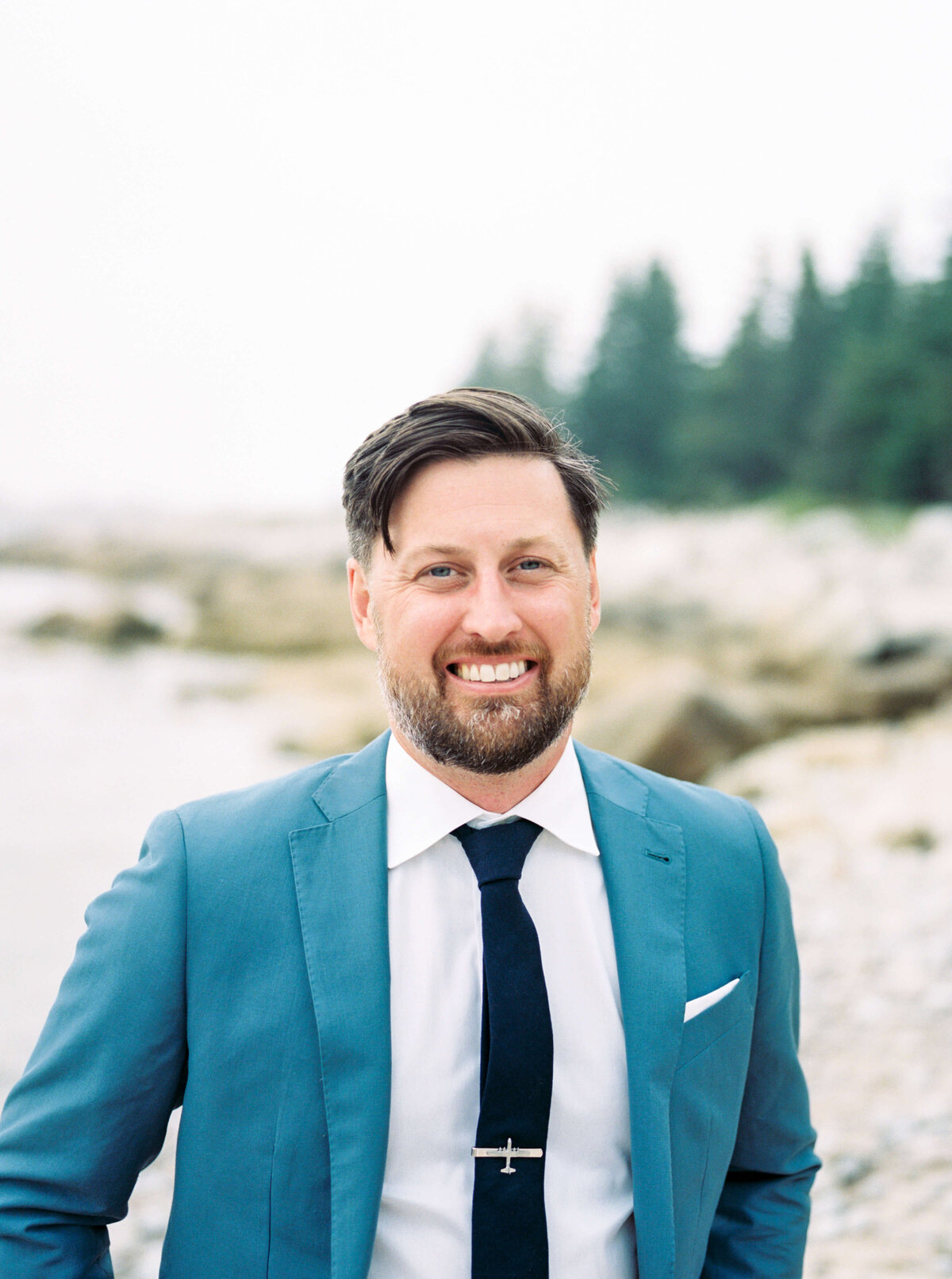 Close up of groom wearing blue suit at Oceanstone Resort Wedding in Nova Scotia