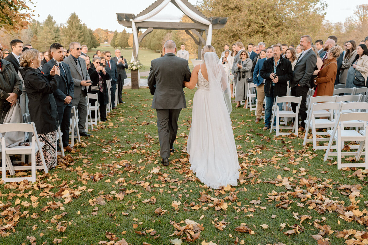 bride walks down aisle with father