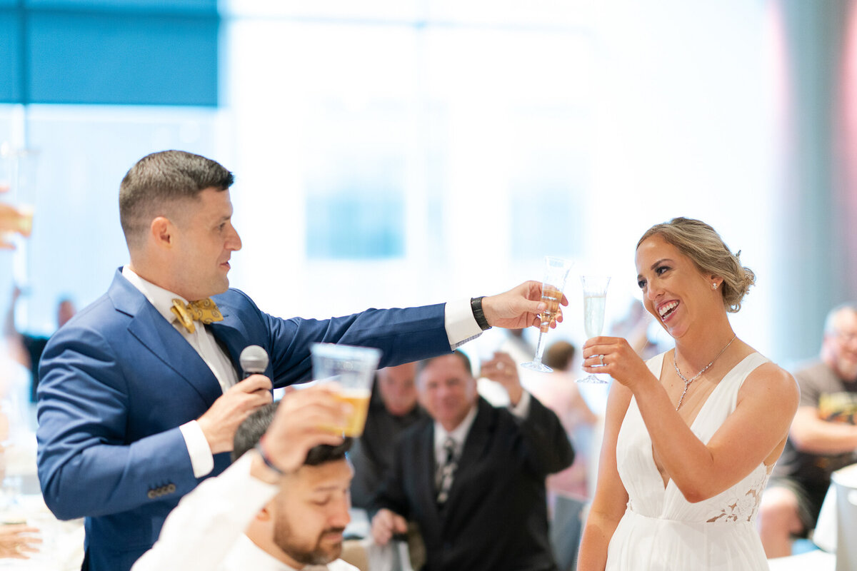 Bride and groom toast drinks at wedding in Saint Paul, Minnesota.