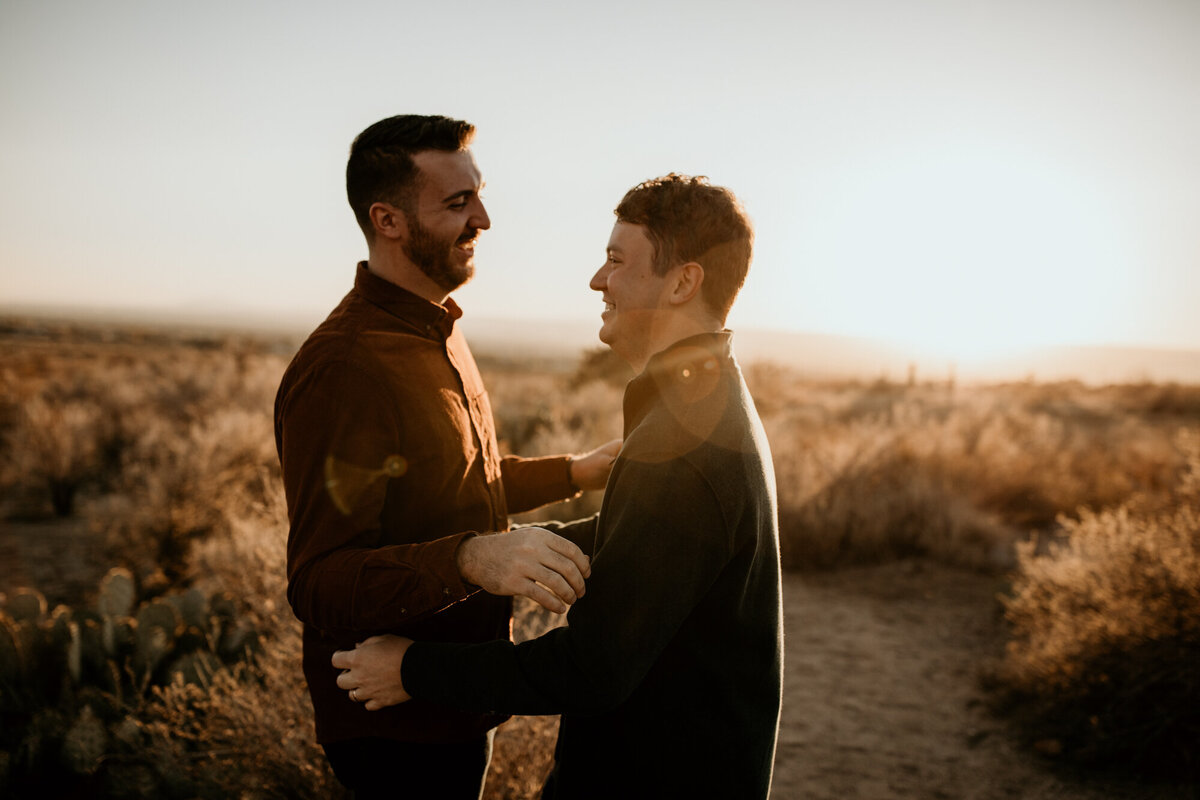 two men about to hug in the desert