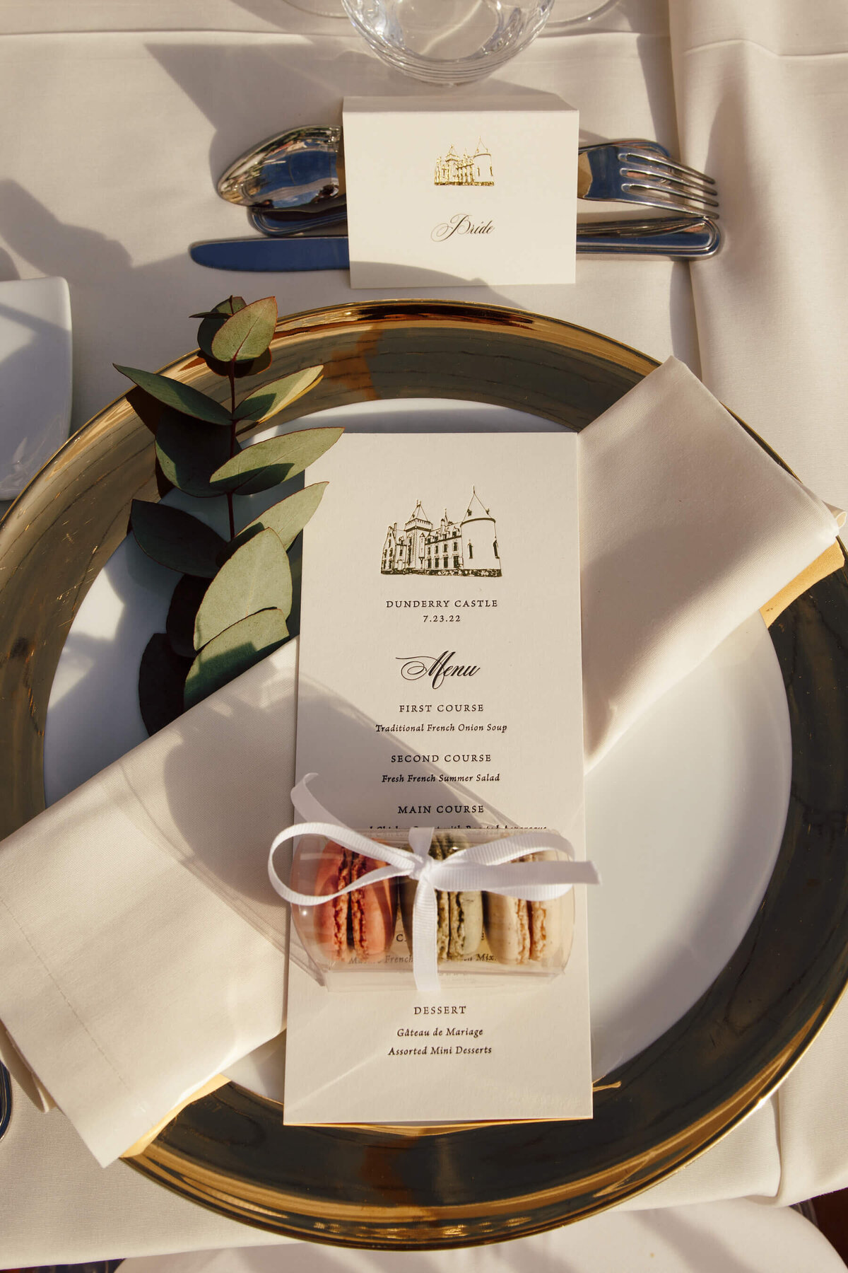 Gold foil menu cards with castle wedding venue illustration