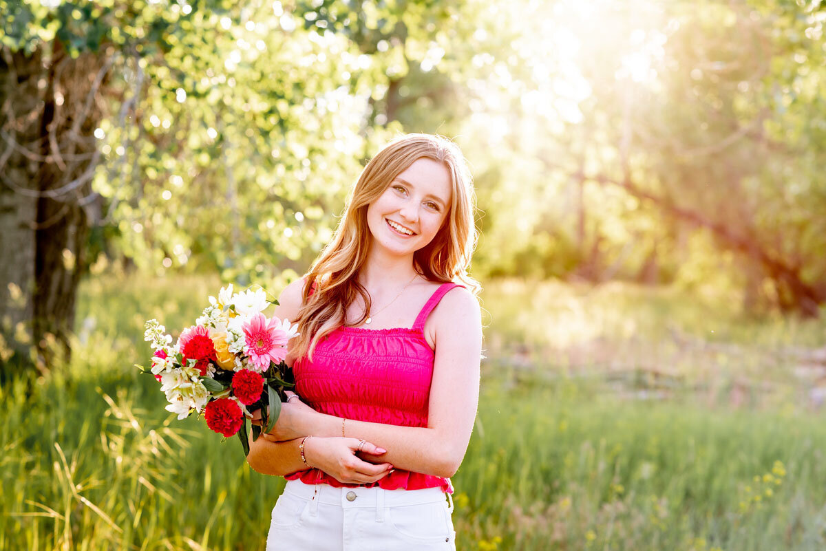 high-school-senior-girl-17-mile-farm-smiling-with-flowers-colorado