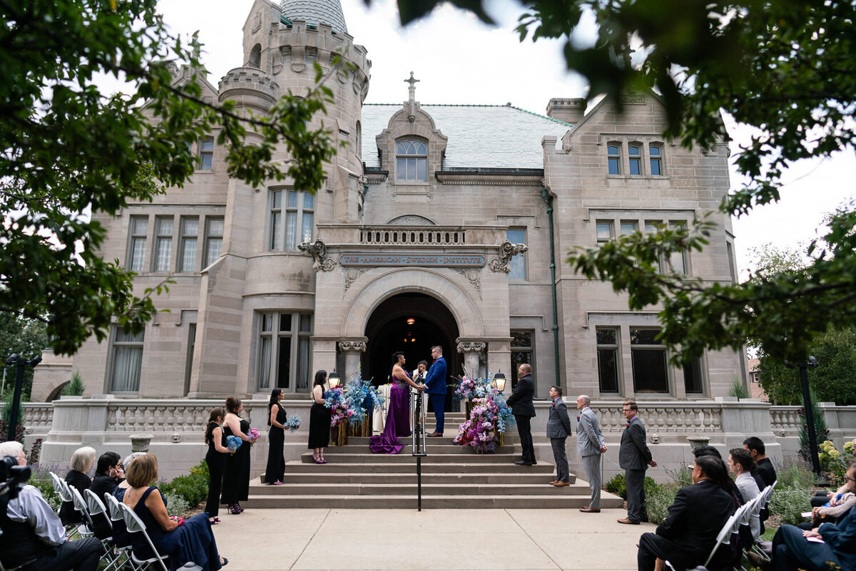Bride and groom get married outside the American Swedish Institute in Minneapolis, Minnesota.