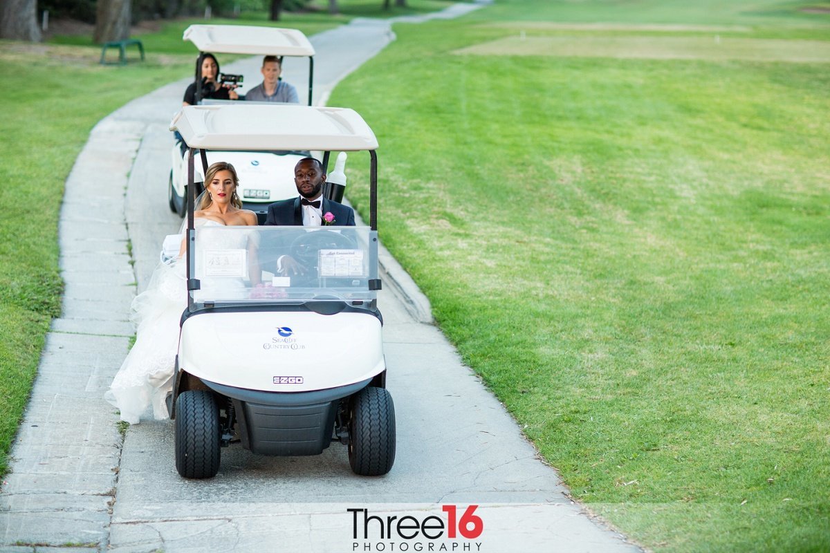 Bride and Groom go for a ride in a golf cart