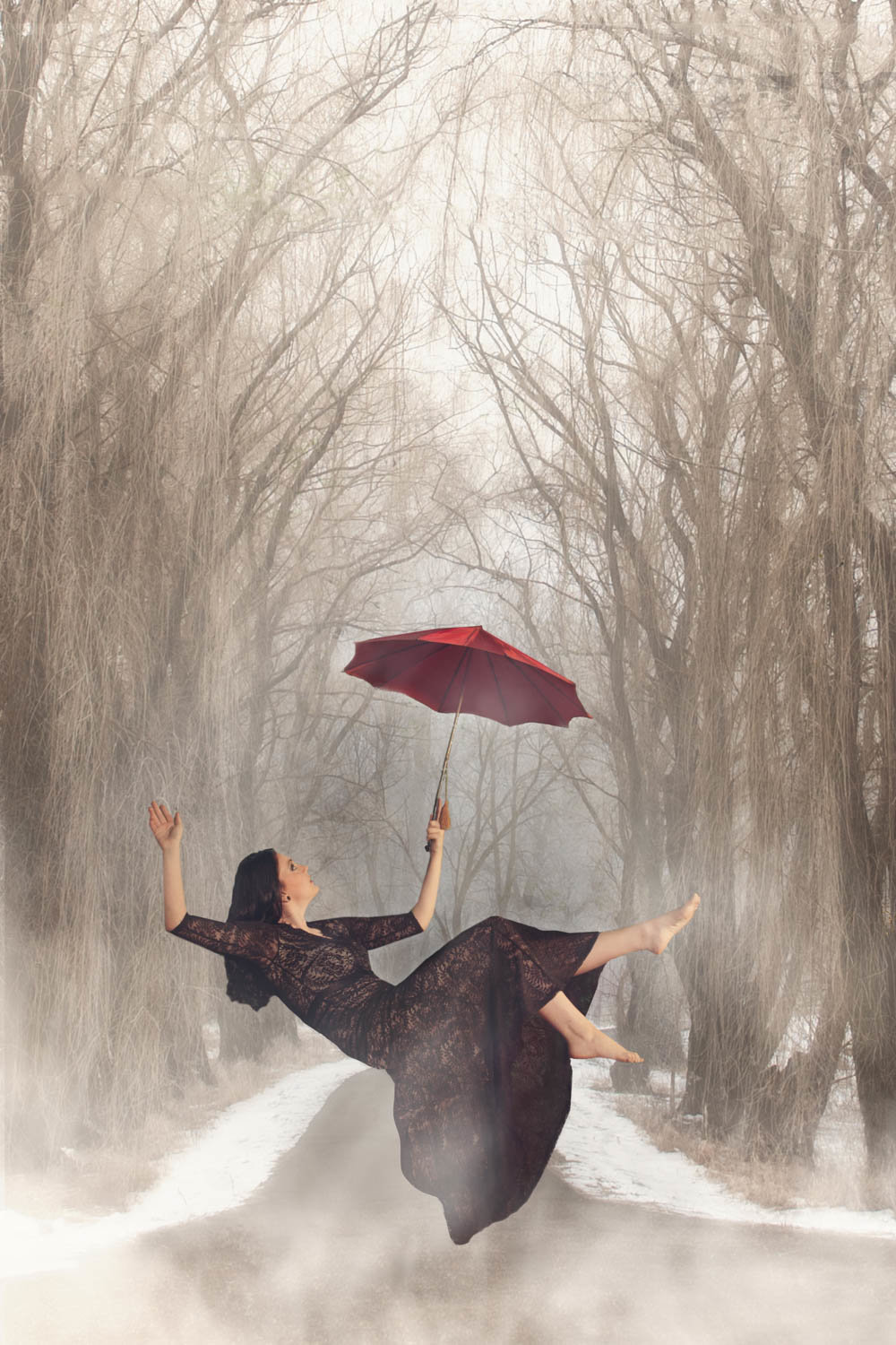 levitation photo of senior girl with red umbrella and formal black dress