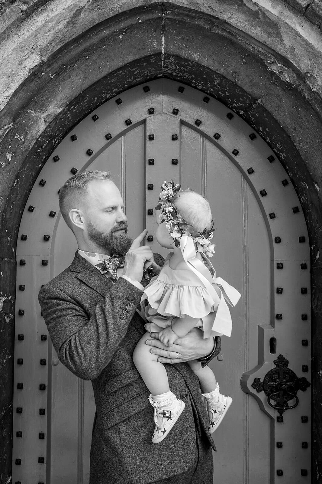 Groom and baby outside Bearsted church