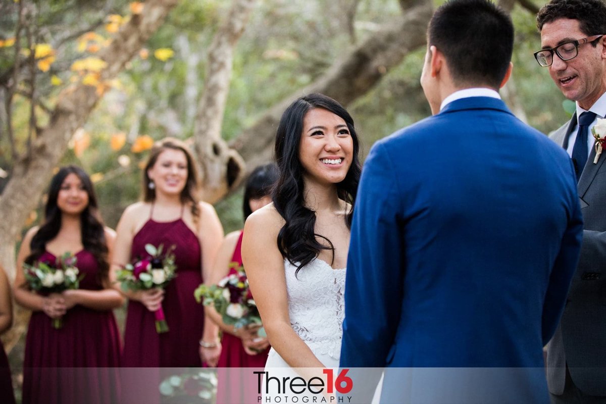 Bride smiles at her Groom as the officiant performs the wedding