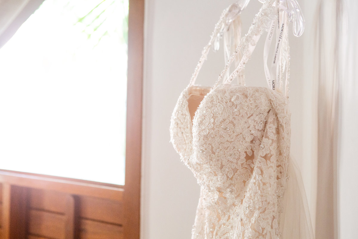 Dallas wedding dress hanging by window