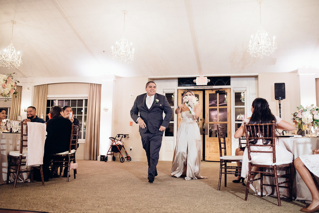 Wedding Photograph Of Groomsman And Bridesmaid Passing The Reception Hall Los Angeles