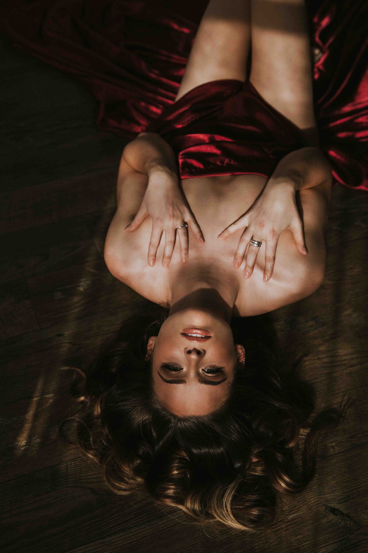 woman laying on the floor  wearing only a sheet.