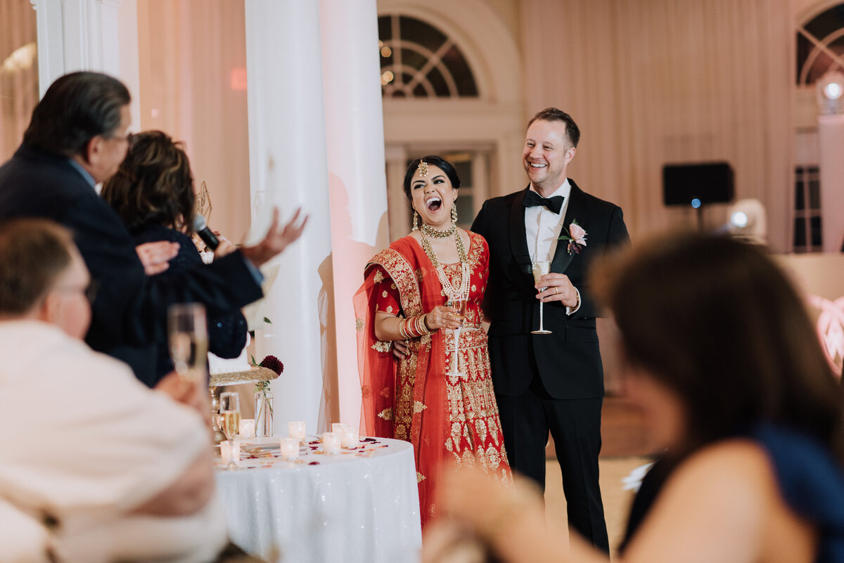 Our newlyweds laugh while hearing their family toast during their big day during their reception in our elegant Pavilion.