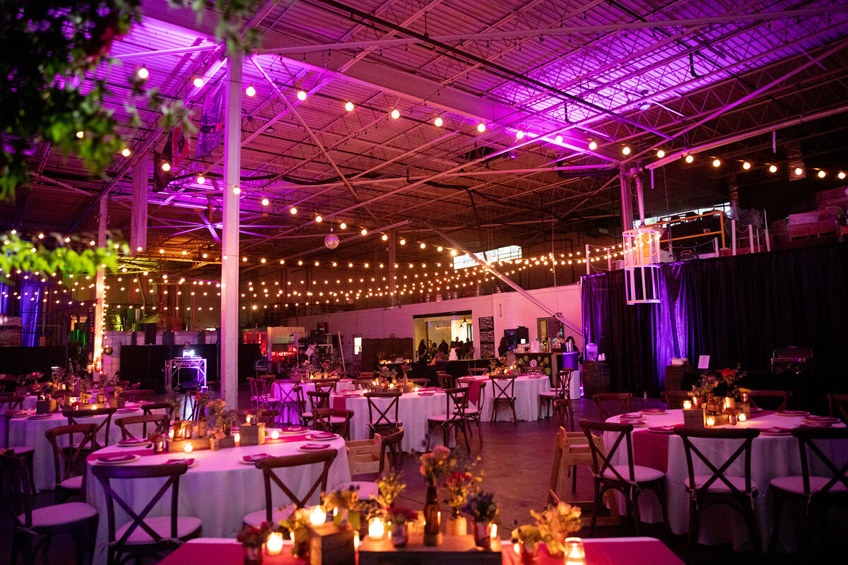 Event space at Captain Lawrence Brewery decorated with pink orange and gold lights Elmsford wedding photographer
