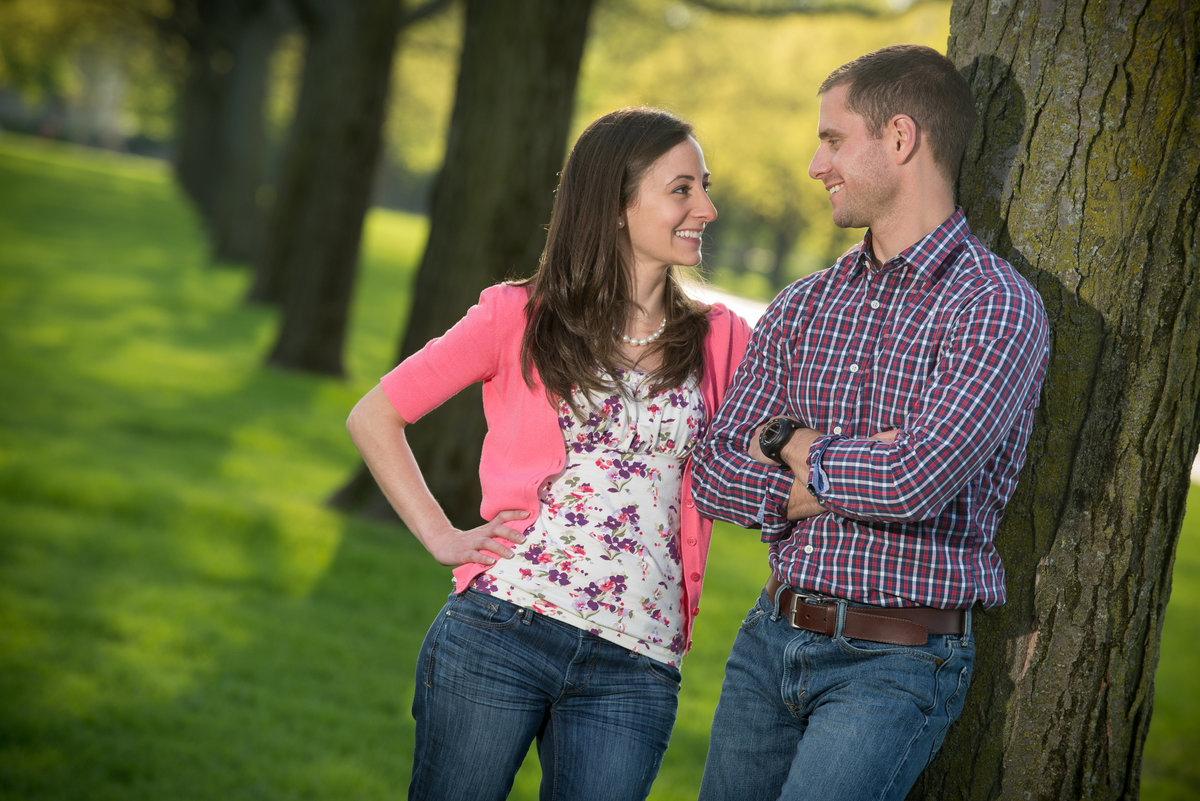 Engagement couple among a row of large trees at cantigny park