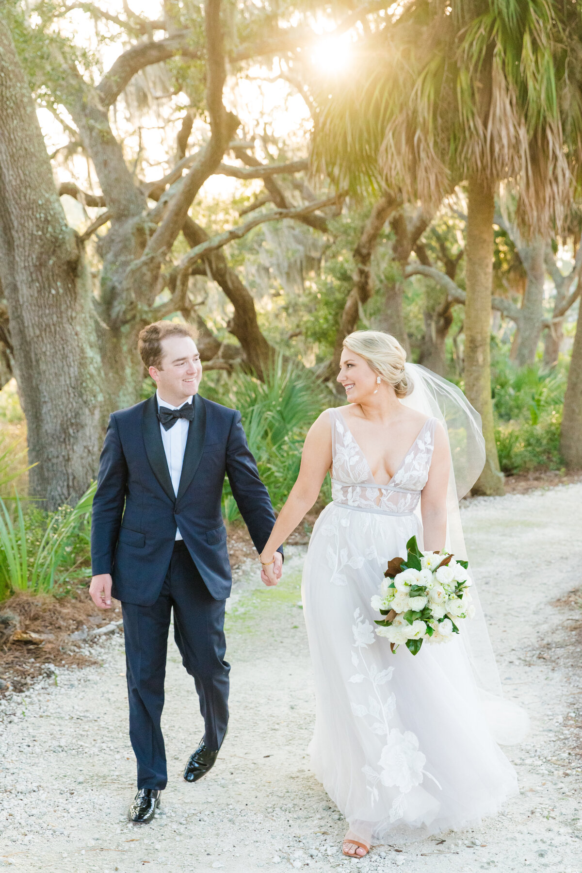 couple walks together on their montage palmetto bluff wedding day