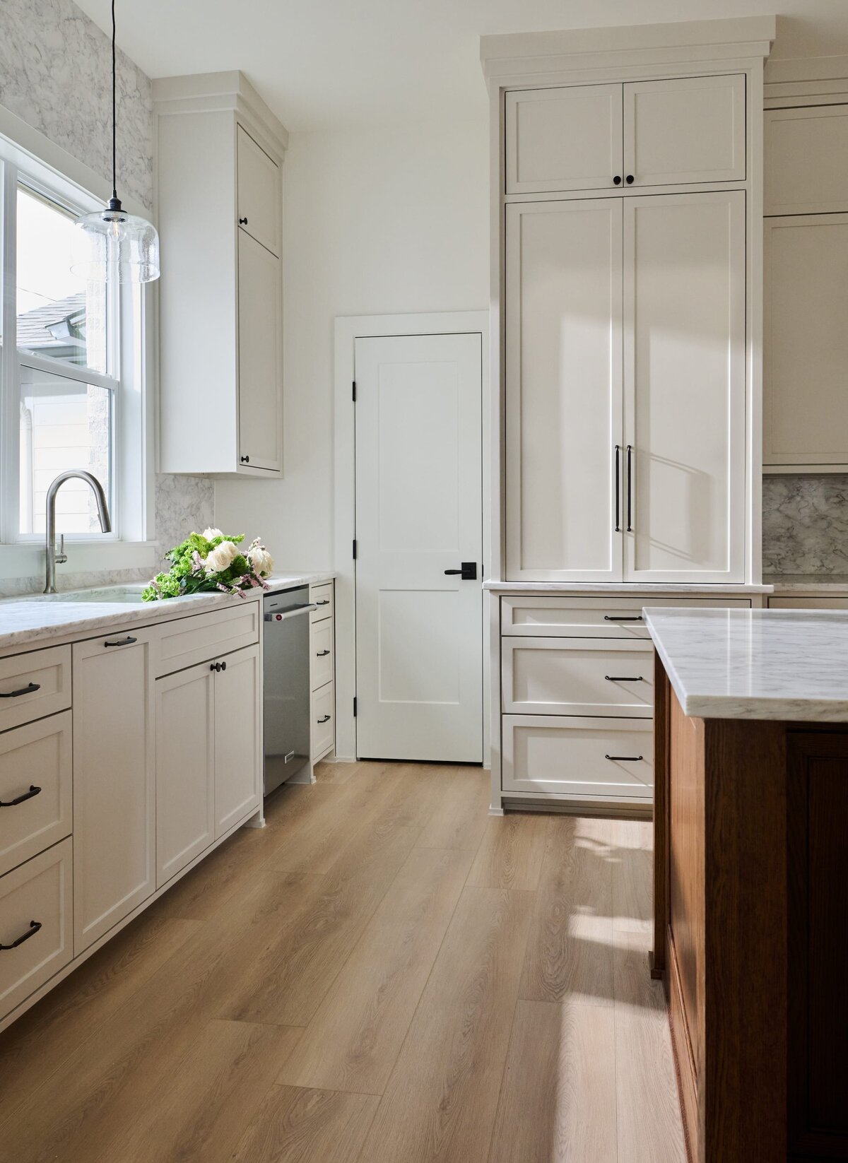 cocoloba homes graham kitchen with wood floors and black hardware