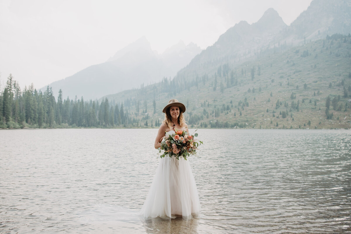 Jackson Hole Photographers capture bride wearing hat holding bridal bouquet