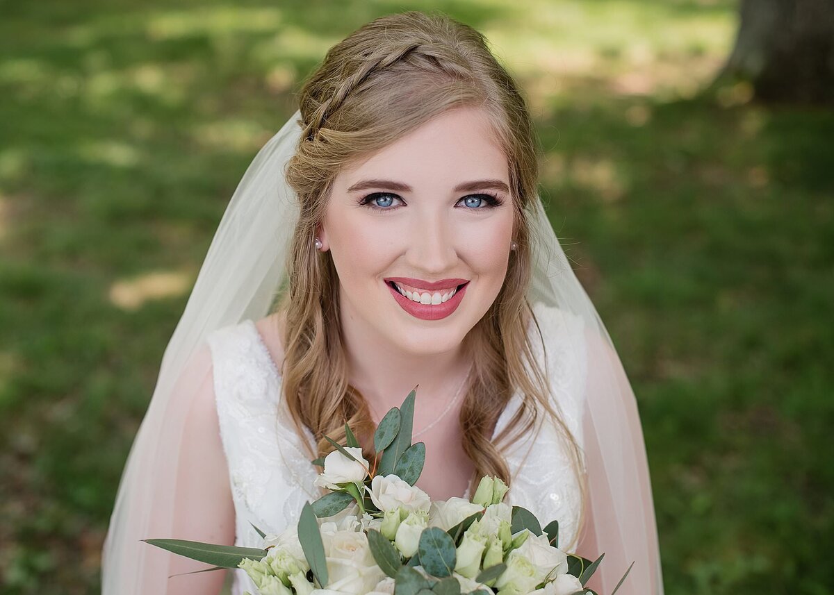 blond bride with blue eyes smiling