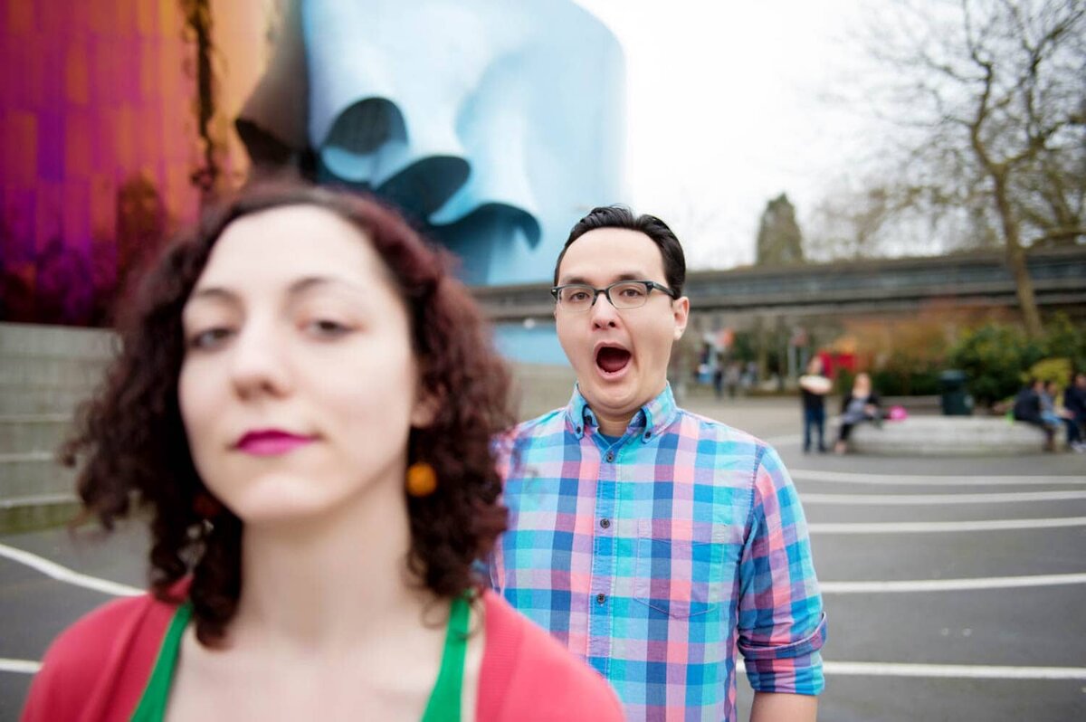 a man in a colorful shirt yawns during engagement session in seattle