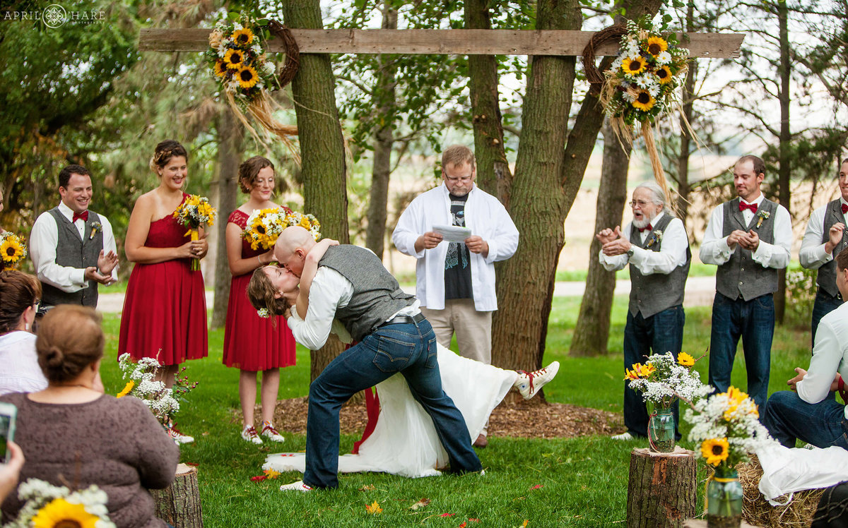 Dramatic Wedding Kiss at outdoor Fall wedding ceremony on a Nebraska Farm
